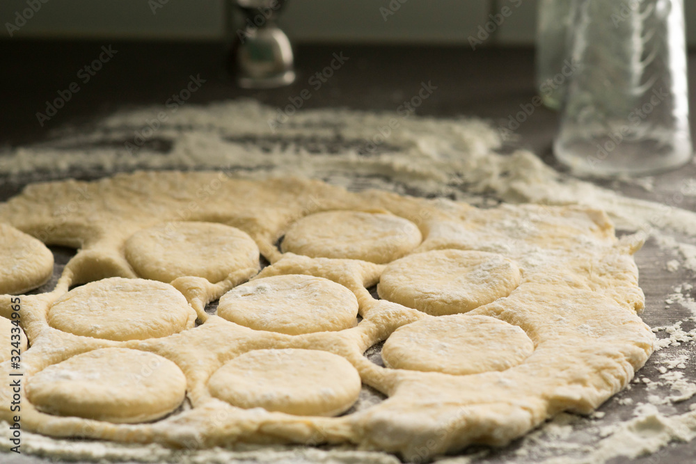 Fresh raw pastry cut into circles with a glass to make a homemade doughnuts, best sweet snack for Fat Friday - february European holiday Fresh raw pastry cut into circles with a glass to make a homemade doughnuts, best sweet snack for Fat Friday - february European holiday