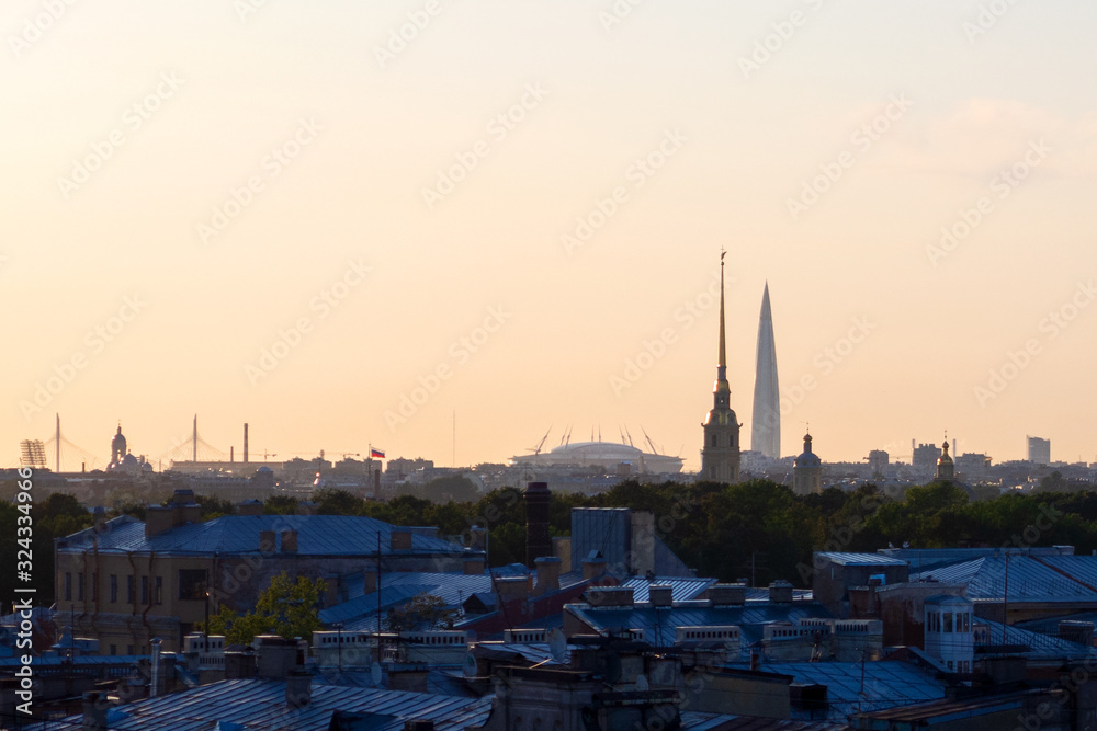 ST. PETERSBURG. RUSSIA - August 28, 2019. Krestovsky stadium, the Lakhta Center skyscraper and the Peter and Paul Fortress against a bright sunset sky