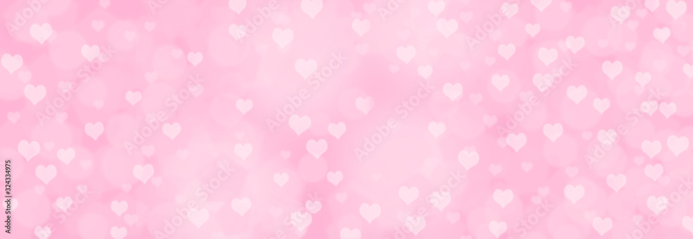 Abstract soft pink bokeh background - Romance or love concept - blurry bokeh circles with hearts on pastel pink background.