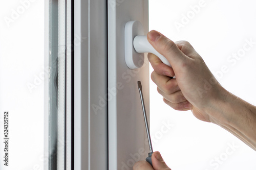 Handyman installing and repair the lock in front plastic door and window.