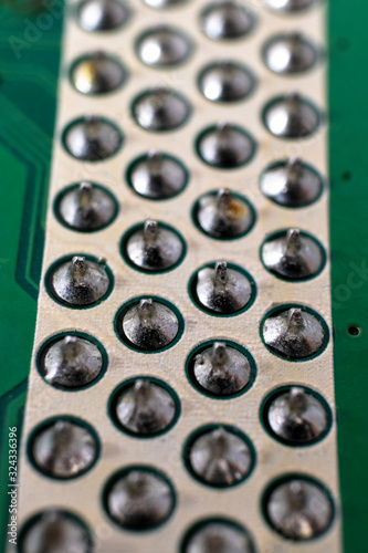 Soldered component pins on an LCD TV motherboard underside photo