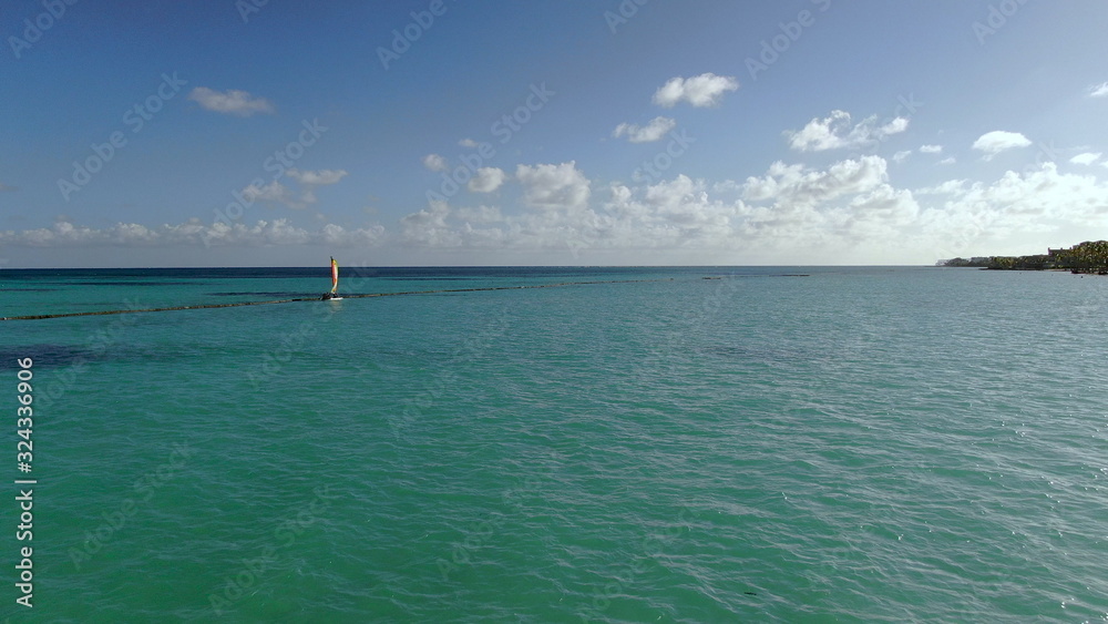 Recreational sailing on small catamaran in turquoise Caribbean sea in Dominican Republic, beach fun and watersports, active vacation lifestyle