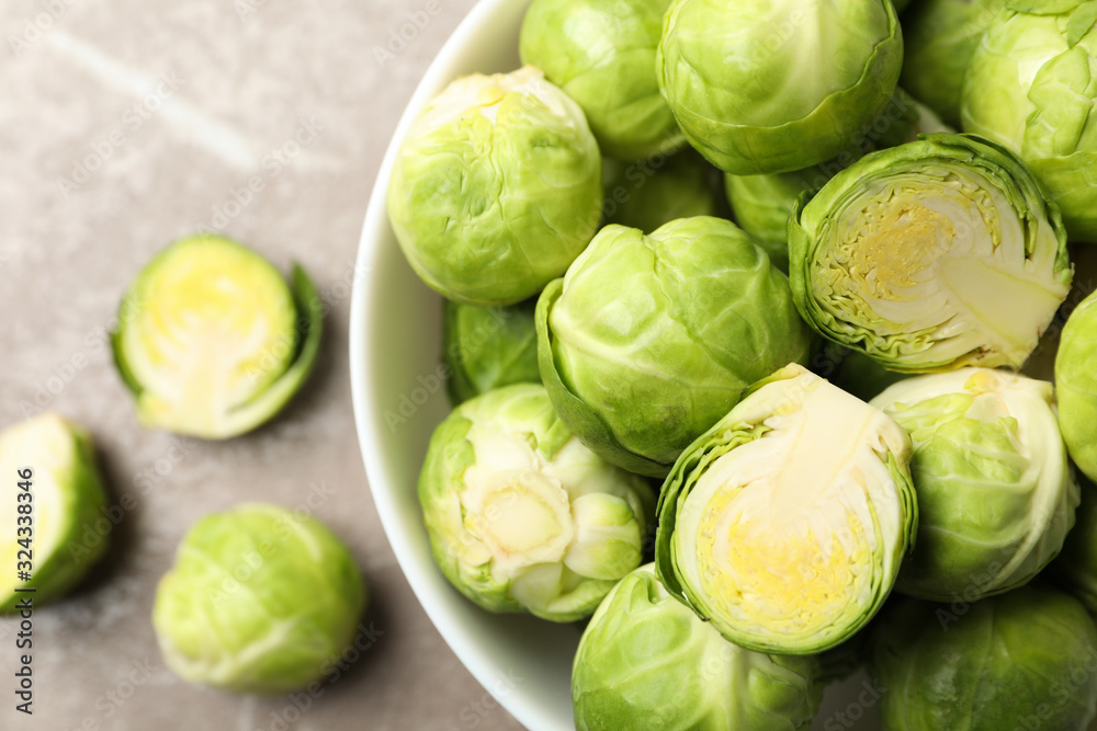 Bowl with brussels sprout on grey background, close up