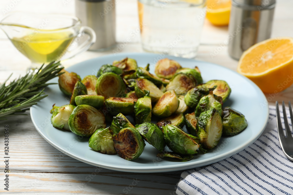 Composition with plate of brussels sprout on wooden background, close up Composition with plate of brussels sprout on wooden background, close up