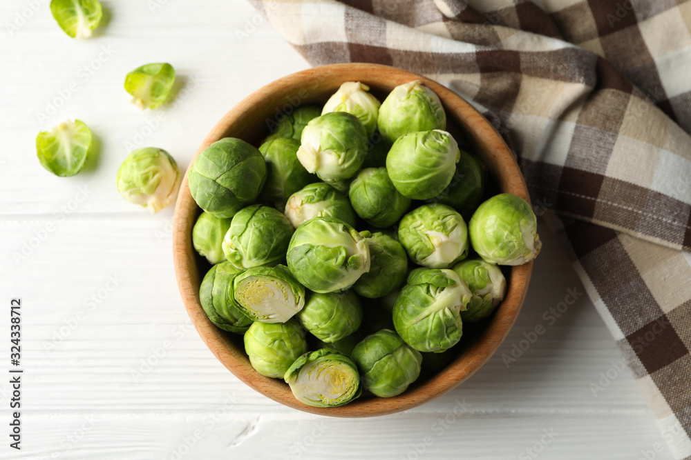 Bowl with brussels sprout on wooden background, top view Bowl with brussels sprout on wooden background, top view