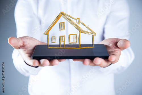 man hand tablet with house model
