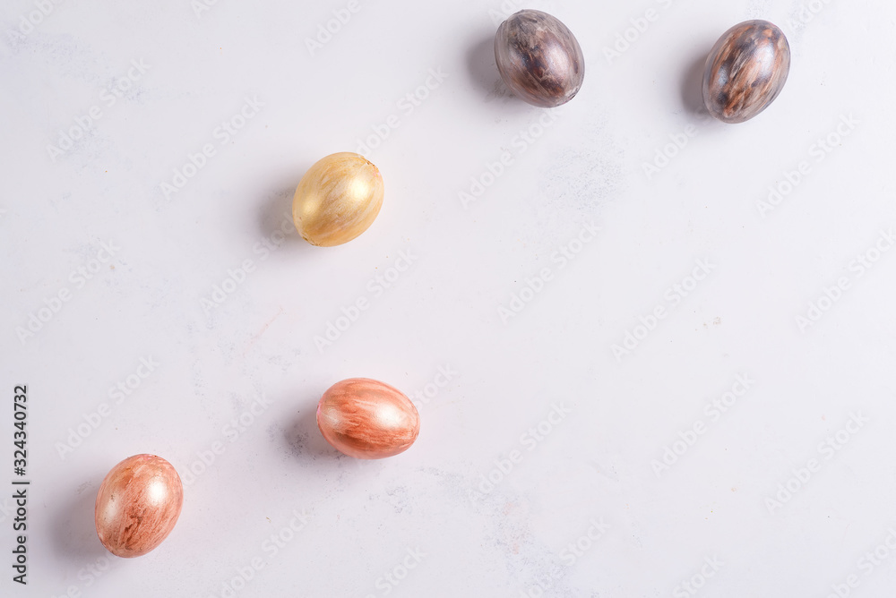 Beautiful Easter silver and gold eggs on marble background