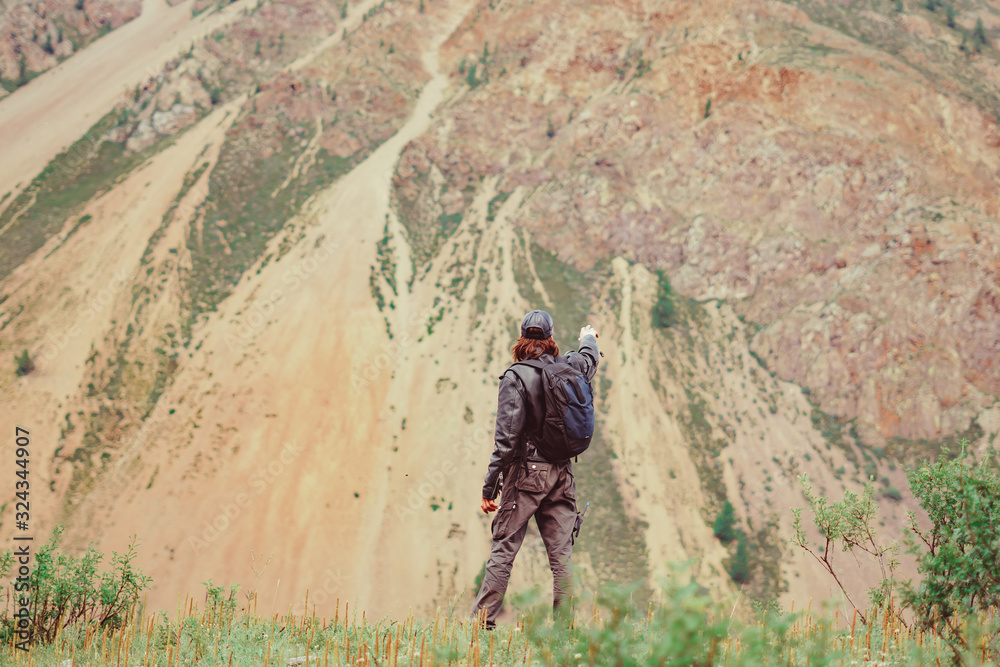 guy with a backpack near the mountains