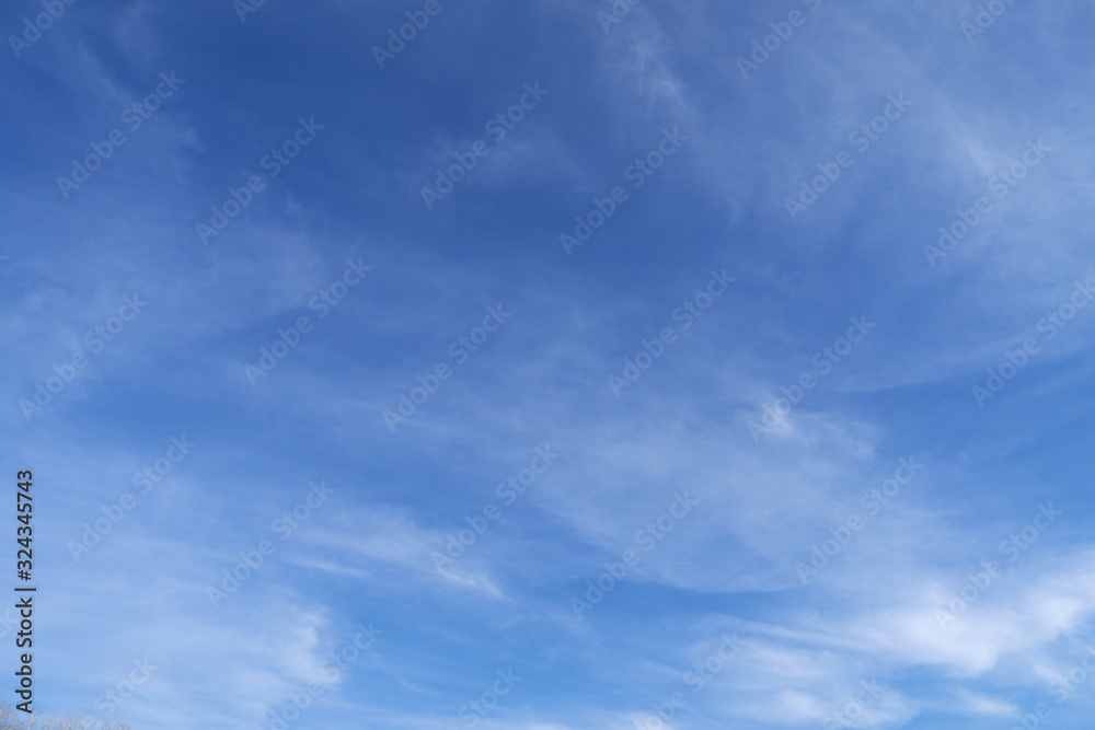 Bright beautiful blue sky with soft clouds for background or texture Bright beautiful blue sky with soft clouds for background or texture