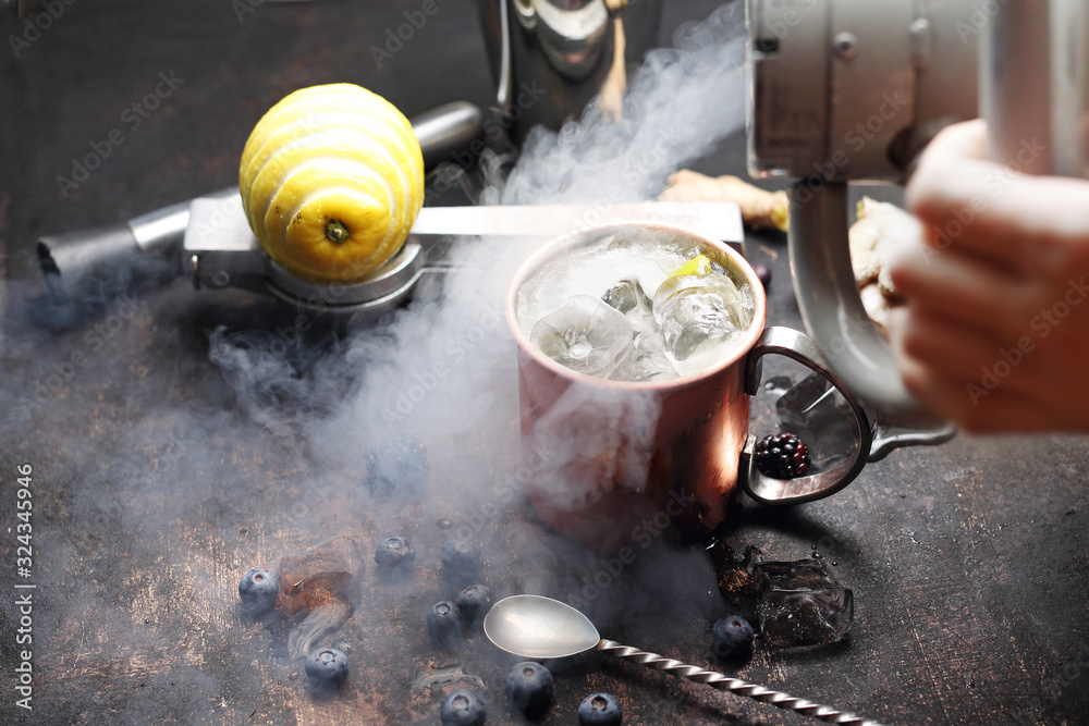 Molecular gastronomy, the bartender prepares a drink using liquid nitrogen.