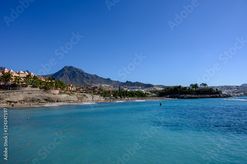 All year sun vacation destination, blue ocean water on beach Playa del Duque in Costa Adeje, Tenerife island, Canary, Spain