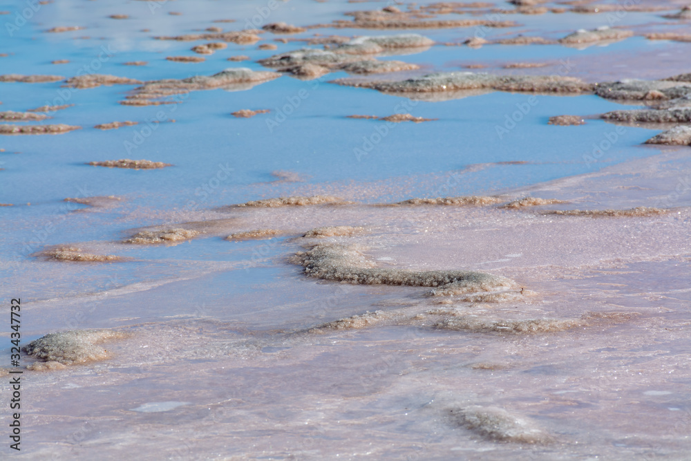 Background with Dead sea high salinity surface with salt rocks Background with Dead sea high salinity surface with salt rocks