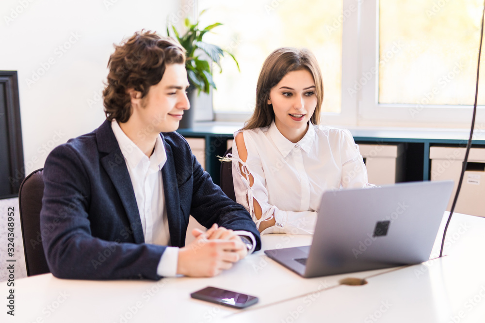 Business people discussing new project on the laptop. Teamwork concepts. Business people discussing new project on the laptop. Teamwork concepts.