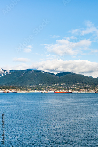 Vancouver, British Columbia, Canada - December, 2019 - Mountain View with clouds in a Beautiful blue sky day. © MontenegroStock