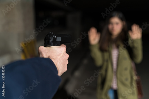 Bandit Holding Handgun Against Young Woman In Alley