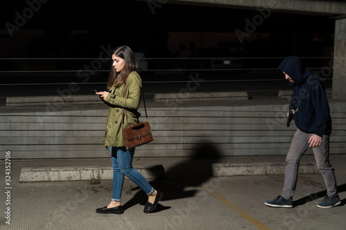 Criminal Walking Behind Unsuspecting Woman