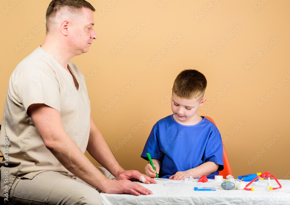 happy child with father with stethoscope. father and son in medical uniform. family doctor. trust and values. small boy with dad in hospital. medicine and health. happy child play with dad happy child with father with stethoscope. father and son in medical uniform. family doctor. trust and values. small boy with dad in hospital. medicine and health. happy child play with dad