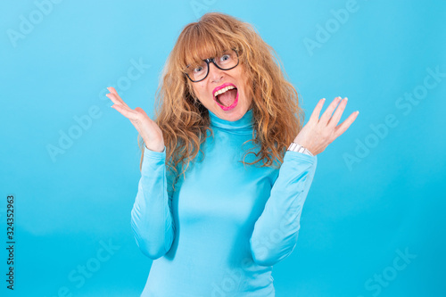adult or senior woman isolated on blue background
