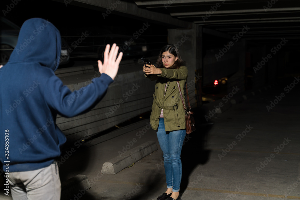 Criminal Raising Arms In Front Of Woman With Weapon Criminal Raising Arms In Front Of Woman With Weapon