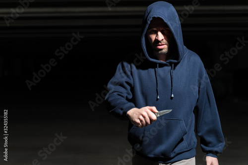 Fototapeta Robber With Weapon Wearing Hoodie