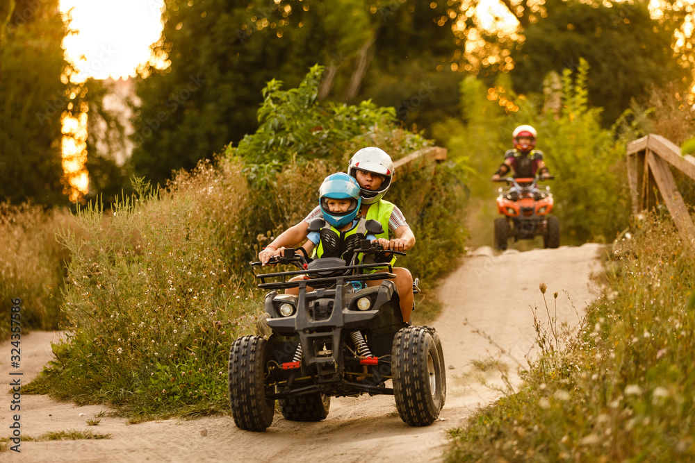 little boy with instructor on a quad bike little boy with instructor on a quad bike