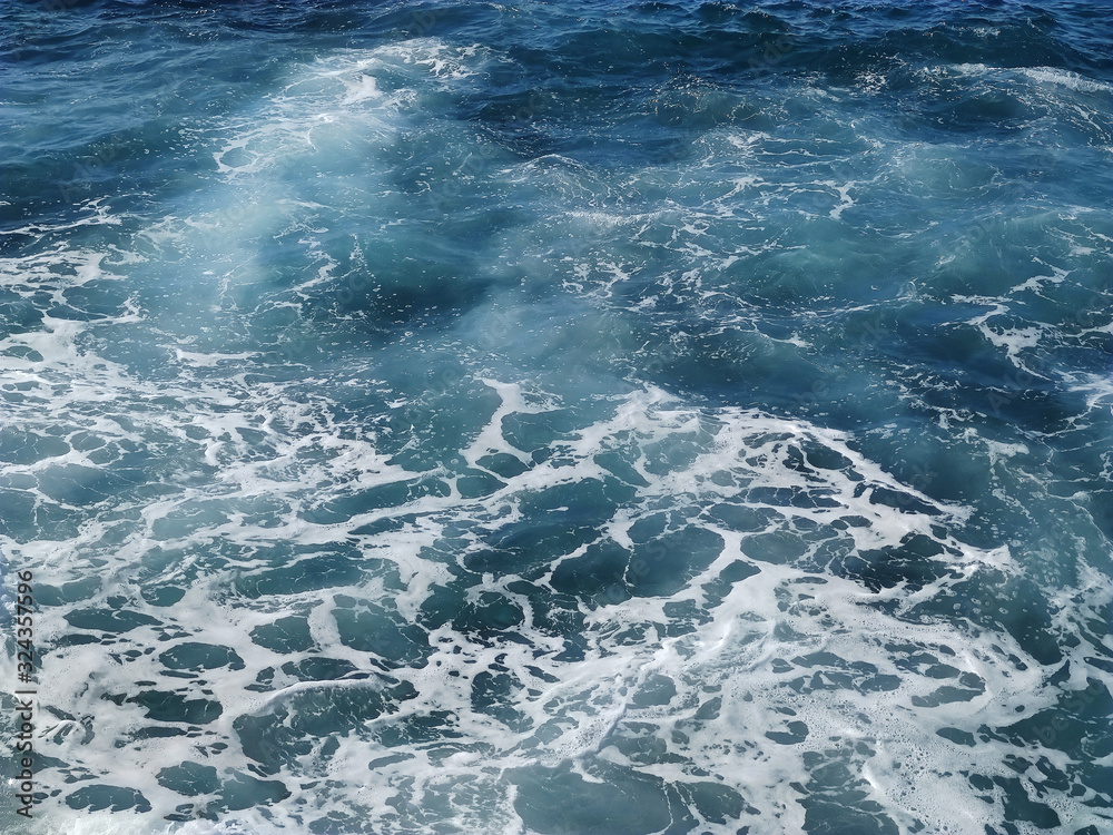 View of the sea waves from above. Sea water with foam. View of the sea waves from above. Sea water with foam.