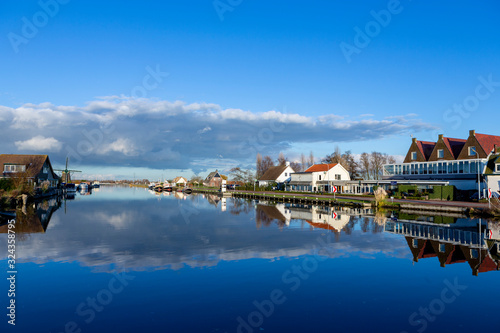 Reflections of clouds in the Ringvaart canal at the Lisserdijk in Lisse. On a sunny day in the Netherlands. photo