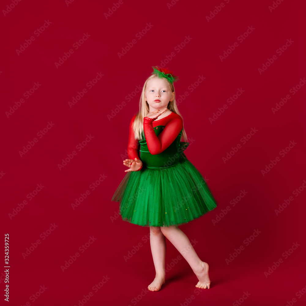 Kid dancer satisfied with concert outfit. Kids fashion. Kid fashionable green dress looks adorable. Clothes for ballroom dance. Ballroom dancewear fashion concept.
