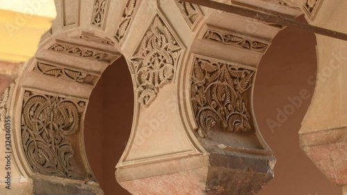 Ornaments in arches in Nasrid palace of the Alcazaba, Malaga, Spain photo