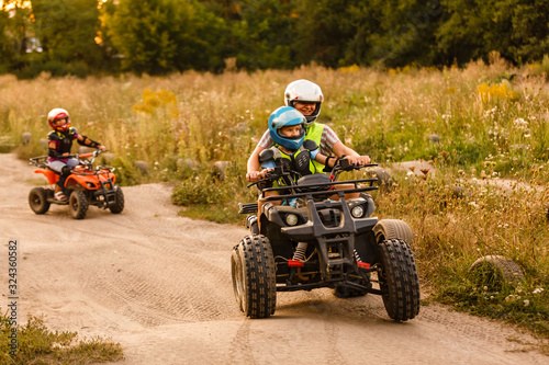 little boy with instructor on a quad bike