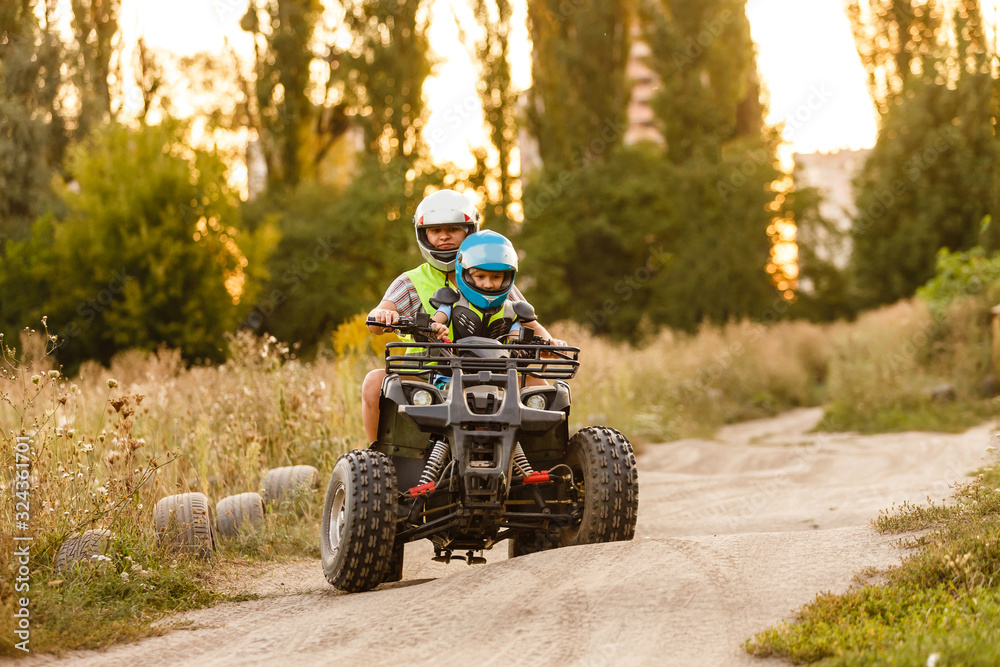 little boy with instructor on a quad bike little boy with instructor on a quad bike