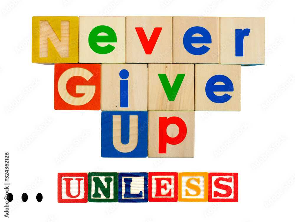 Inspirational NEVER GIVE UP concept spelled out in colorful toy blocks with caveat UNLESS qualifier. Inspirational NEVER GIVE UP concept spelled out in colorful toy blocks with caveat UNLESS qualifier.