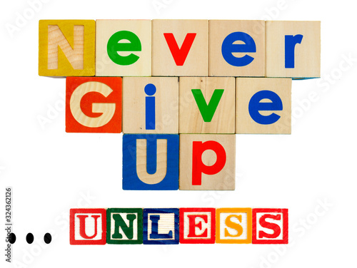 Inspirational NEVER GIVE UP concept spelled out in colorful toy blocks with caveat UNLESS qualifier.