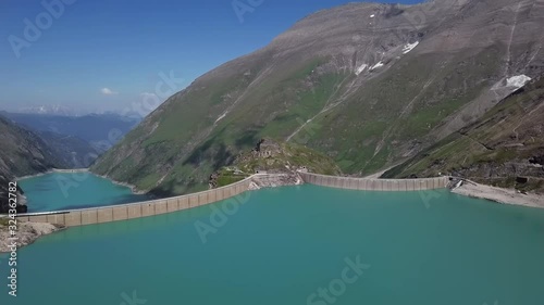 Flight over of Kaprun high mountain reservoirs Mooserboden Stausee in the Hohe Tauern, Salzburger land, Austria. photo