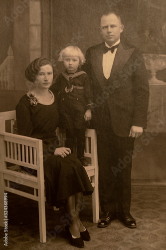 LATVIA- CIRCA 1925- 1930: Shot of married couple and their child in studio, Vintage Carte de Viste Art Deco era photo