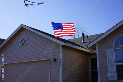 American flag waving on a suburban house