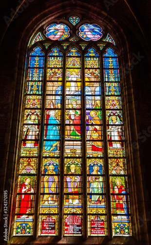 Religious scenes on gothic stained glass window inside St Michael's church inGhent, Belgium © PhotoFires