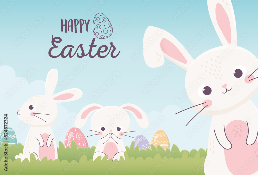 happy easter cute rabbits with decorative eggs in the grass