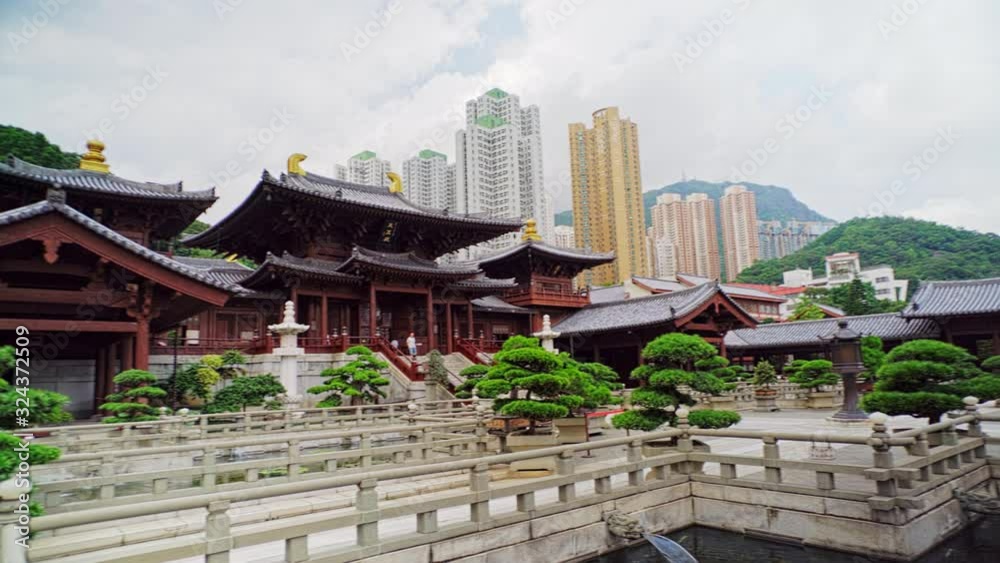Temple in Hong Kong, koi pond, high-rises, mountains Temple in Hong Kong, koi pond, high-rises, mountains