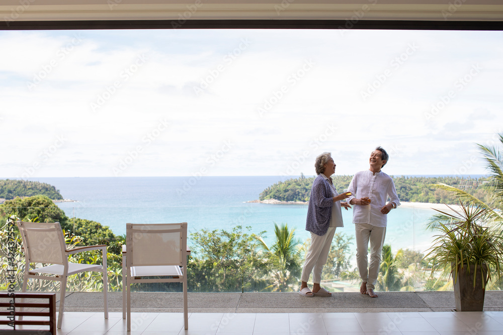 Happy senior Chinese couple relaxing on balcony Stock Photo | Adobe Stock