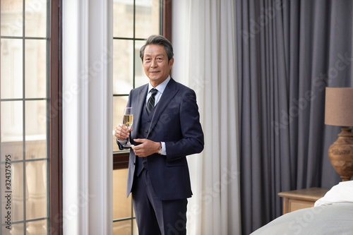 Wallpaper Mural Senior Chinese man drinking champagne at home Torontodigital.ca