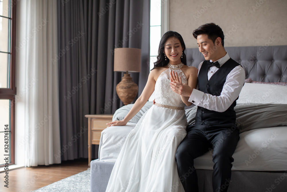Happy young Chinese couple enjoying their love in bedroom Happy young Chinese couple enjoying their love in bedroom