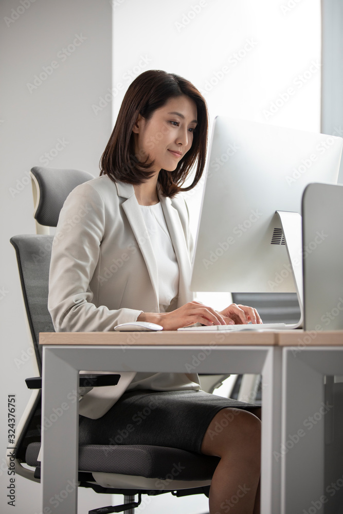 Young Chinese businesswoman working in office Young Chinese businesswoman working in office