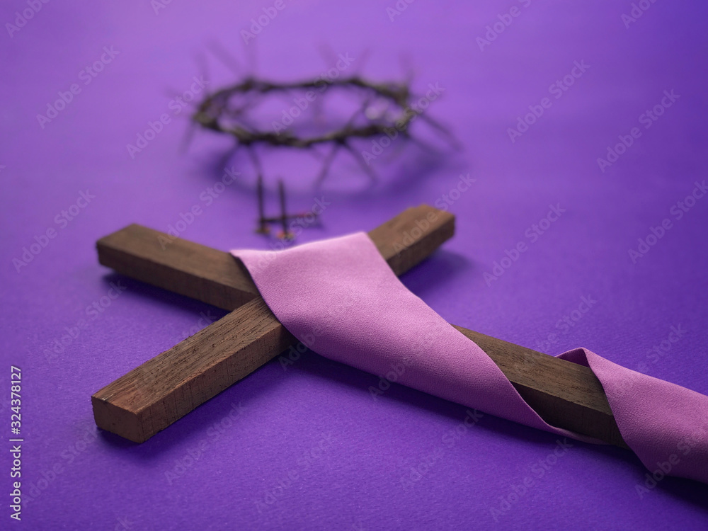 Good Friday, Lent Season, Ash Wednesday and Holy Week concept. Christian cross, a woven crown of thorns and three rusty nails  on purple background.