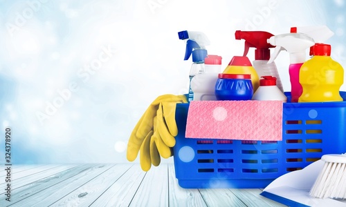 Plastic bottles, cleaning sponges and gloves in bucket
