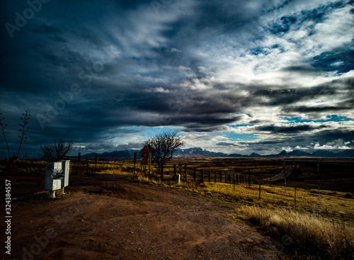 Beautiful, moody view of the meadows and mountains near sonoita, Arizona on a  cloudy winter day with golden grass, blue, white and grey sky in Arizona photo