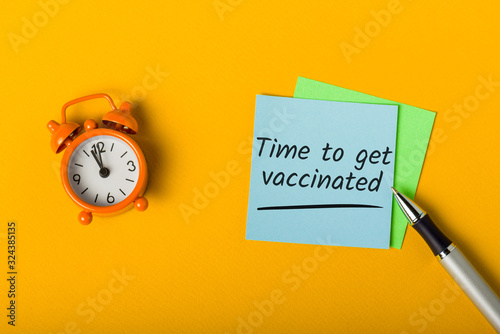 Vaccination concept. Time to get vaccinated - message on orange background