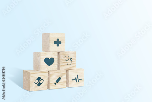 Medical symbols on wooden blocks. Medical and pharmaceutical concept. Medical treatment and public health problems. Signs from medicine on a light background.