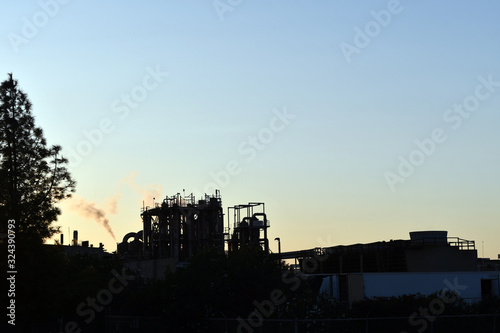 Silhouette of factory at sunrise