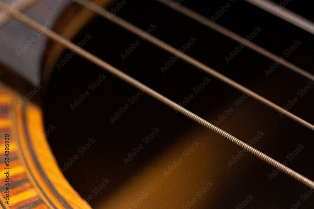 Close up of guitar strings and sound hole decor Close up of guitar strings and sound hole decor
